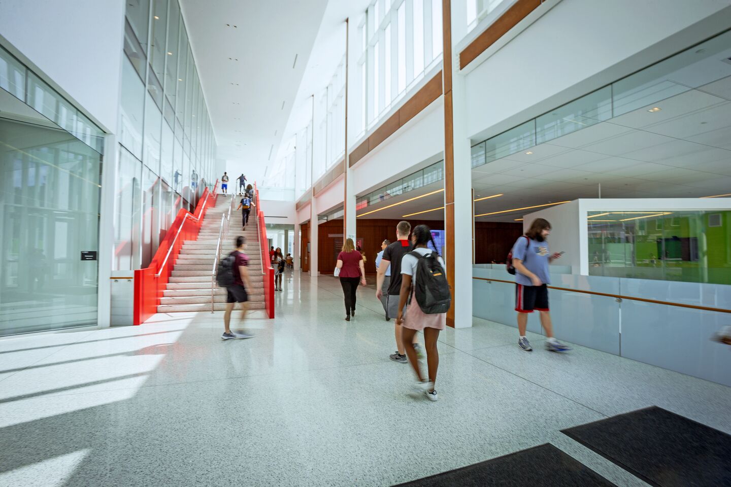Interior of Edward St. John Learning and Teaching Center with students walking.