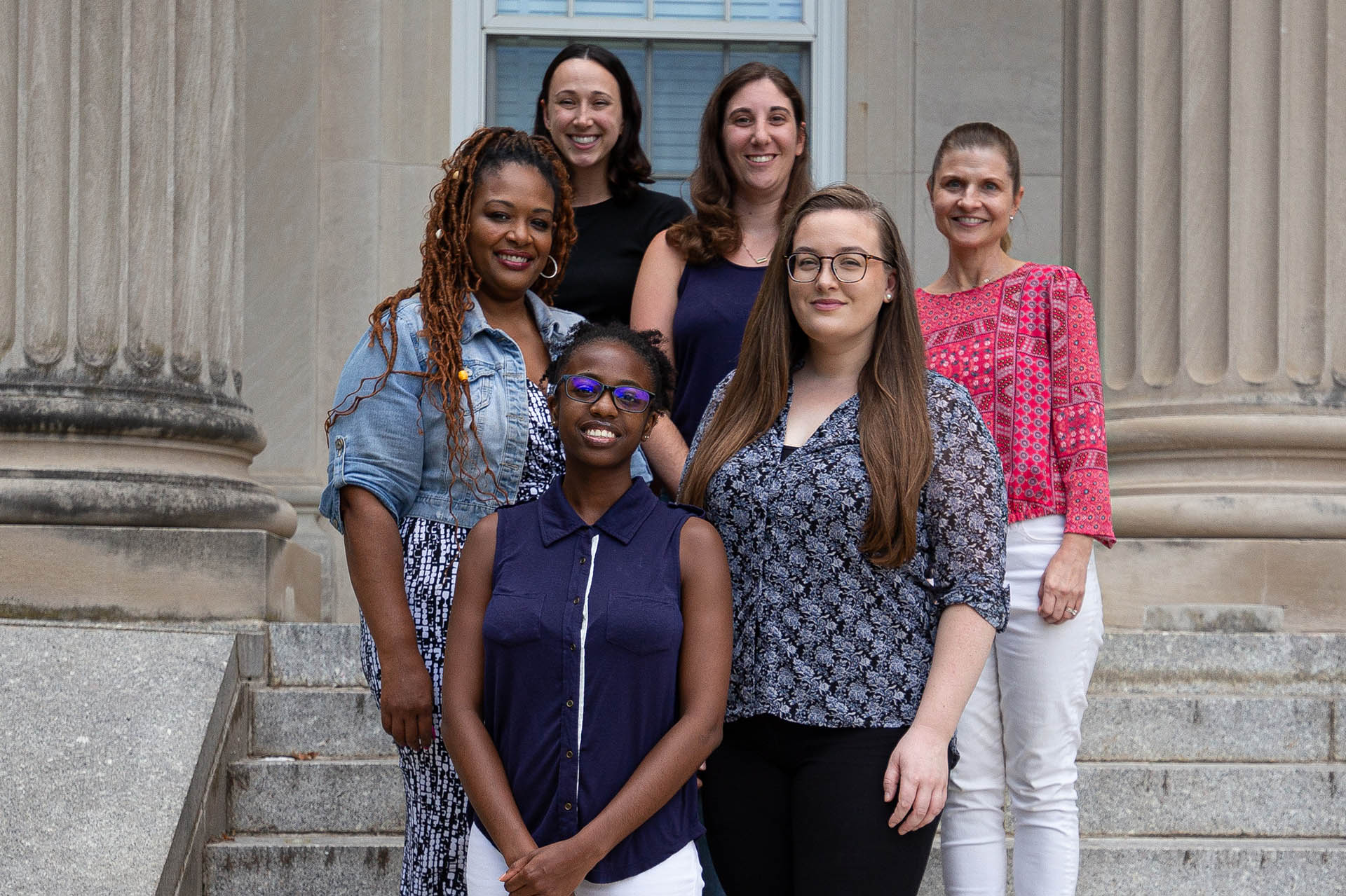 five disability specialists and assistant director posing on the steps of the Shoemaker Building