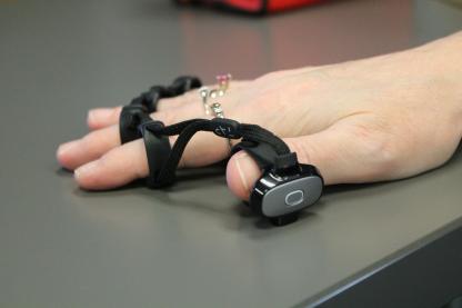 hand on table with adaptive technology equipment