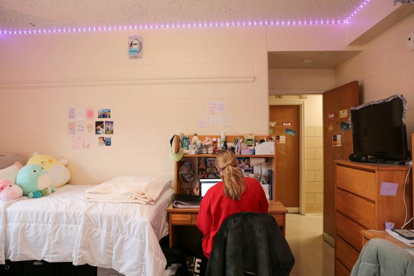 student working on desk in residence hall room