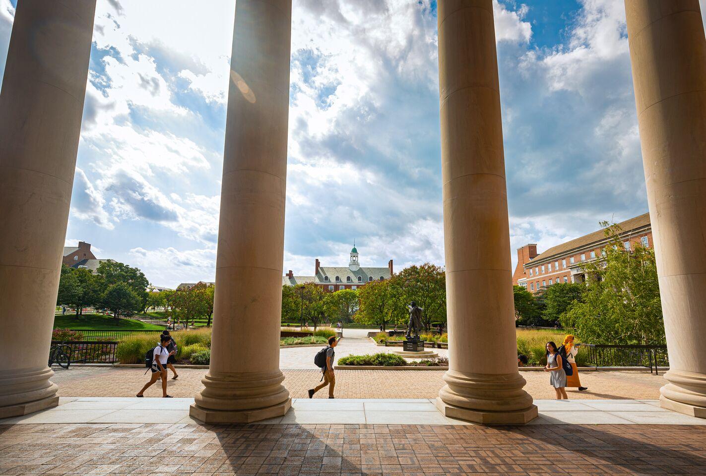 View of Frederick Douglass Square and Hornbake Plaza from under the porch and columns of Hornbake Library.