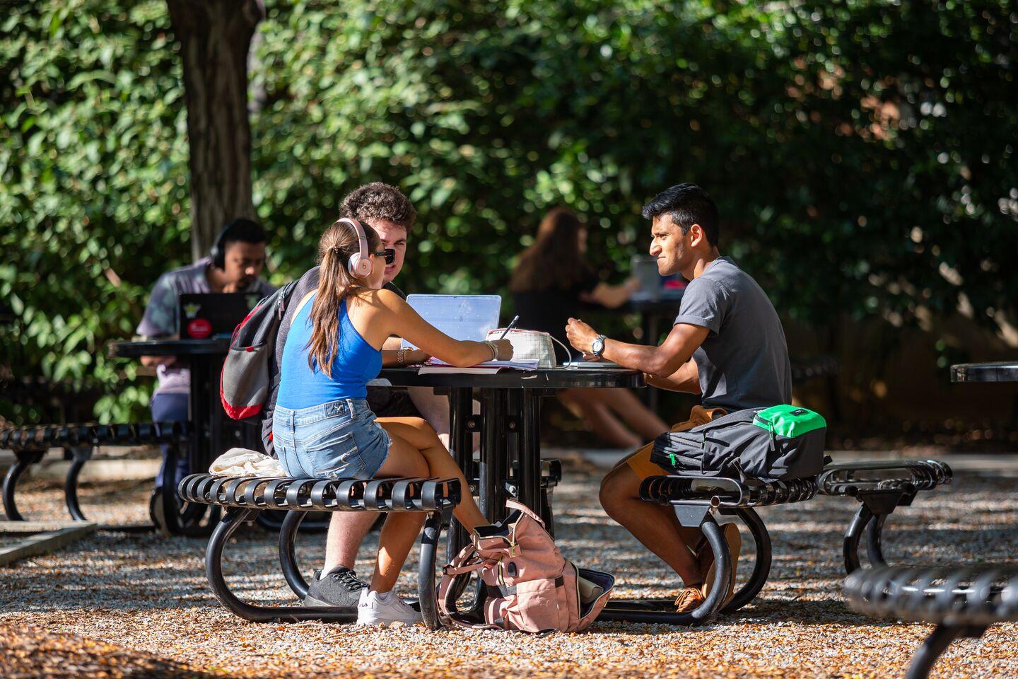 Students working at an outdoor table in Hornbake Plaza.