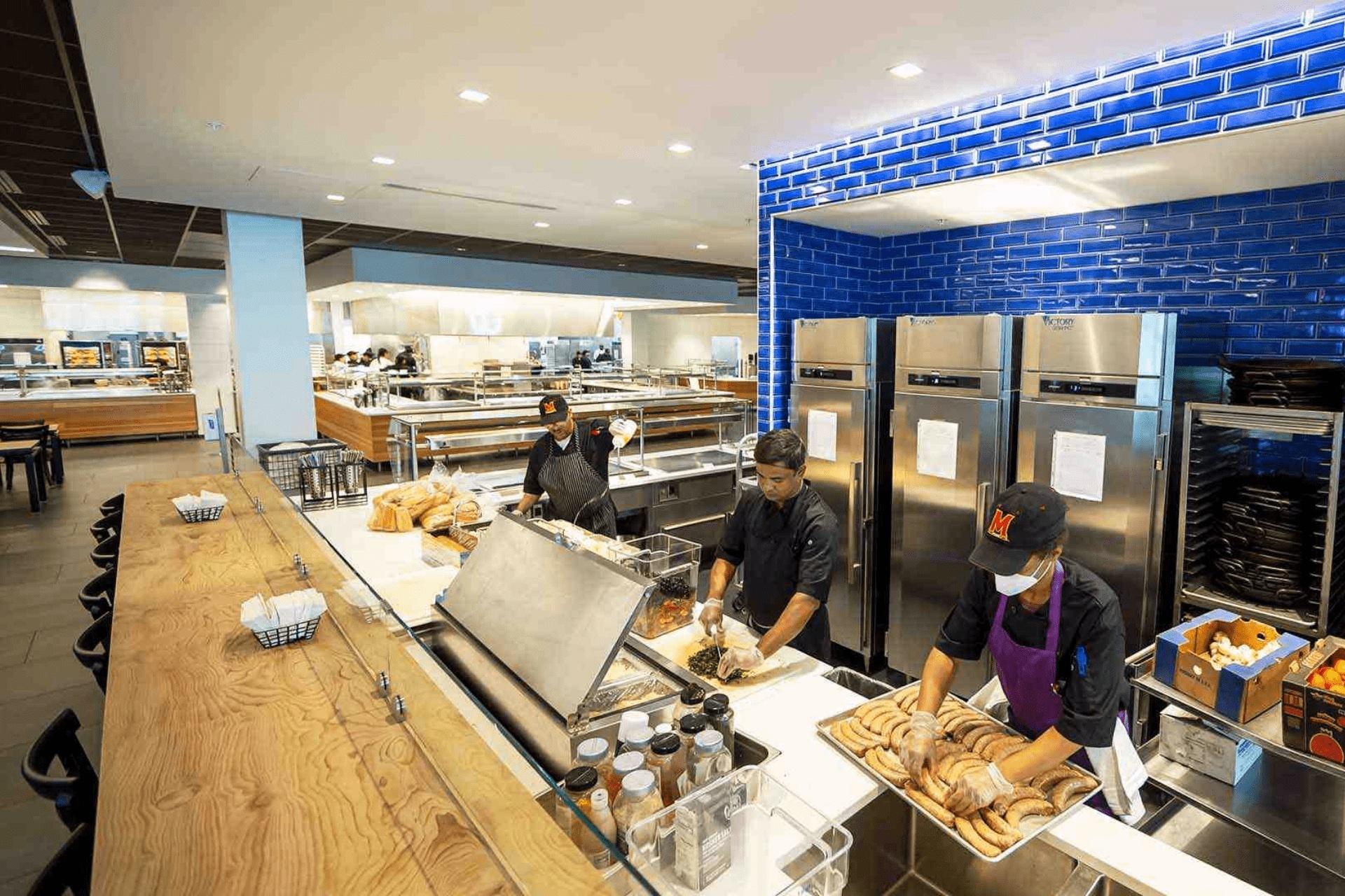 cooks behind one of the dining stations at Yahentamitsi Dining Hall