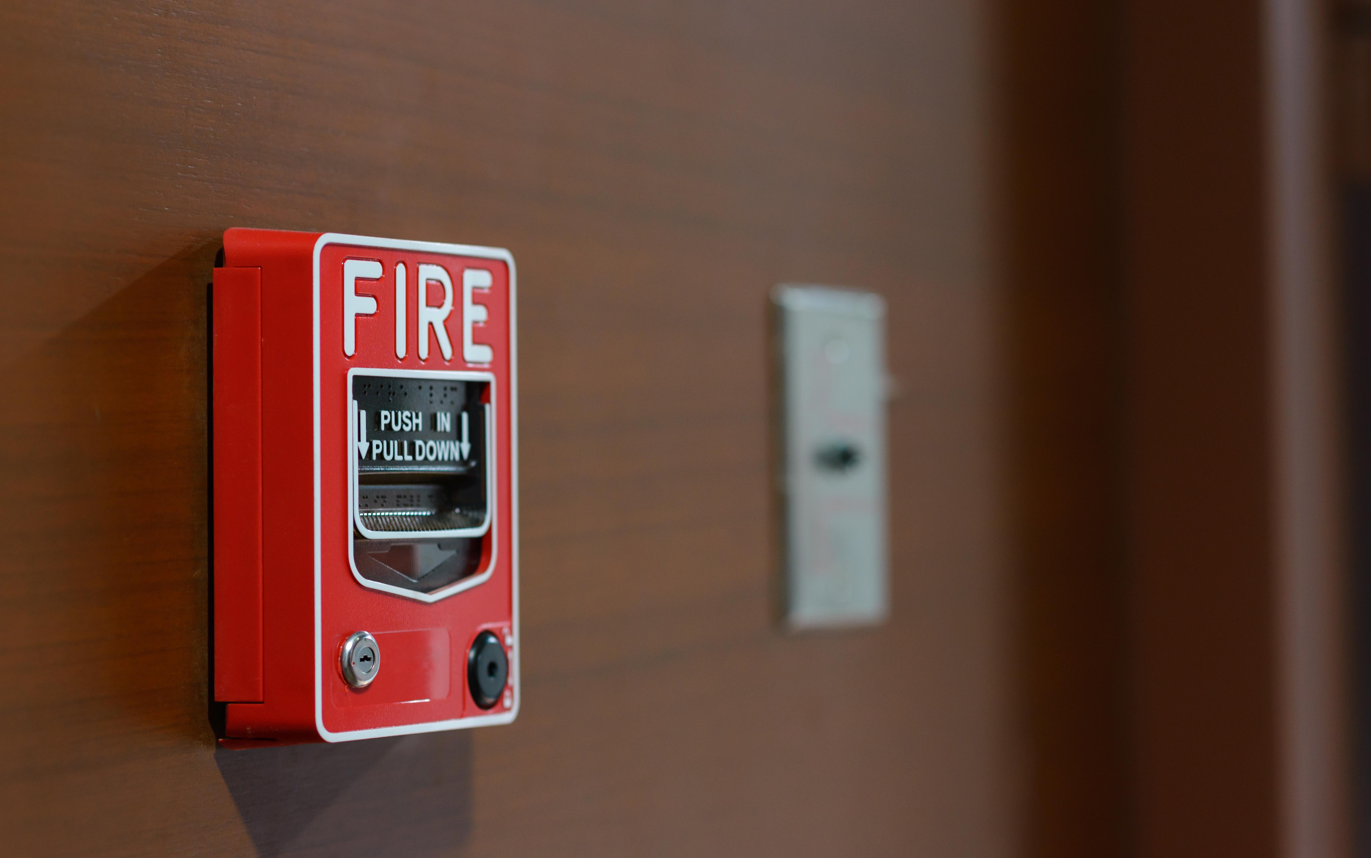 red fire alarm on wall